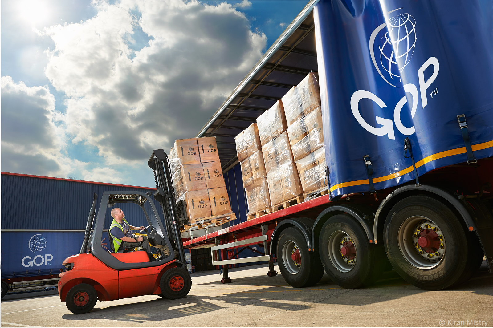 forklift truck loading pallets onto lorry